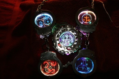 Engraved Glass And Handcuff Jewelry In Darkness